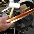 3. With a plastic mallet and V-block, the lengthwise curvature is initiated.