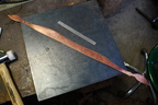 34. Now, starting the vine. Here's the blank of 18 gauge copper, cut out and ready to start forming.