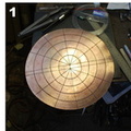 1. Starting with a circular disc of silicon bronze. It's marked so that it is slightly oval, even though it is a circle, the shorter end being the face, which will end up shorter than the hair.