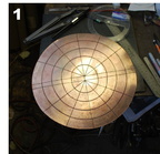 1. Starting with a circular disc of silicon bronze. It's marked so that it is slightly oval, even though it is a circle, the shorter end being the face, which will end up shorter than the hair.
