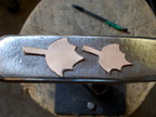 15. A couple of leaves cut out of the same bronze sheet.