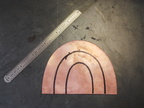 1. Starting with a more-or-less semicircular piece of 16 gauge copper sheet.