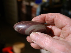 17. That pod-type bulge in the middle of the stem called for something in it. I found this "lingam stone" online, the perfect shape, and the colors are good too.