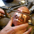 17. Cutting open the mouth with a jeweler's saw. After all, this is to be a teapot, so it has to have a spout.