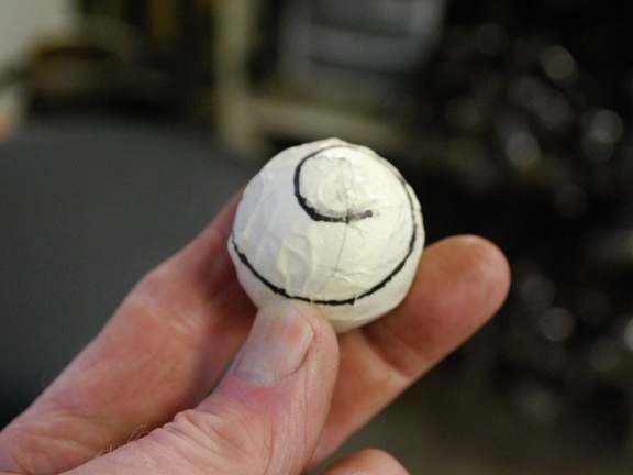 51. Now to start the final piece of the puzzle. Here I have wrapped a ball with a few layers of masking tape, and drawn a spiral line on it.