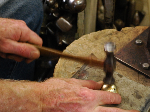 57. Using a planishing hammer, pushing in the bulges to make it more spherical.
