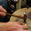 57. Using a planishing hammer, pushing in the bulges to make it more spherical.