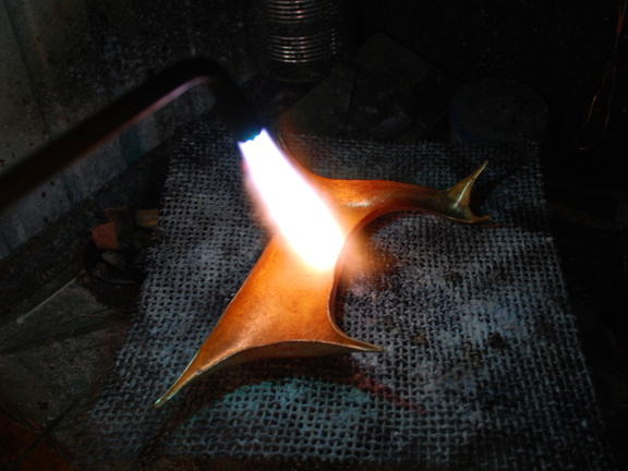 8. Annealing the whole piece, to make the metal malleable again after having been thoroughly work-hardened.