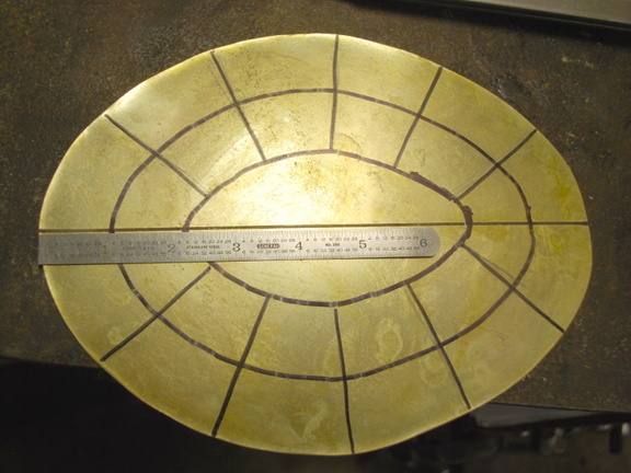 1. A blank of 16 gauge brass, with guidelines drawn on it.