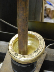6. Using the hydraulic press to push out the ears.