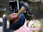 9. Using the tool shown on the left, hammering the ears to stretch the metal upward.