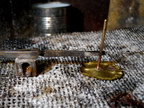 29. A brass rod silver-soldered to the feet. it will fit tightly into a hole drilled in the wood.