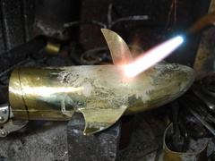 24. Silver-soldering a fin to the body.