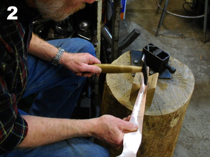 2. Starting the cylindrical form with hammer and wood V-block.